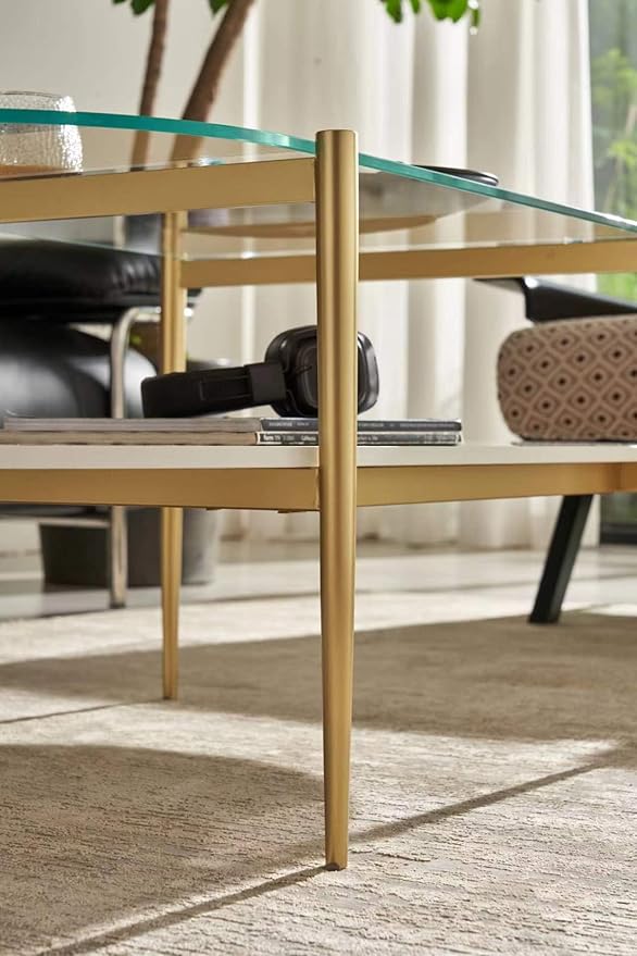 Shrine Oval Coffee Table, Mid-Century Modern Design, 2-Tier Structure, Clear Glass Top and White MDF Shelf, 47" D x 21" W x 17" H, Sleek Conical Metal Legs with Gold Finish