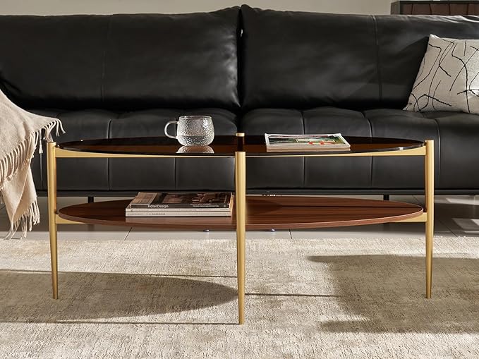 Shrine Oval Coffee Table, Mid-Century Modern Design, 2-Tier Structure, Amber Glass Top and Walnut MDF Shelf, 47" D x 21" W x 17" H, Sleek Conical Metal Legs with Gold Finish