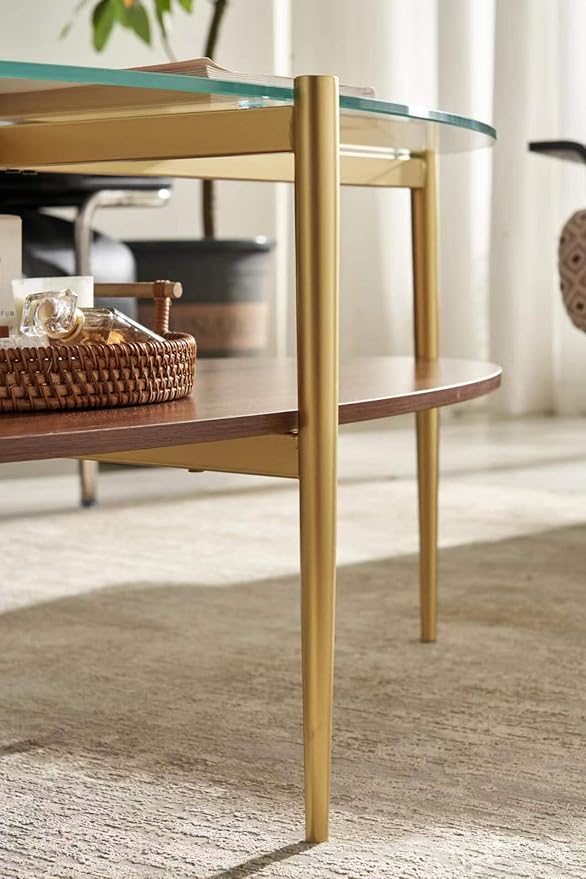 Shrine Oval Coffee Table, Mid-Century Modern Design, 2-Tier Structure, Clear Glass Top and Walnut MDF Shelf, 47" D x 21" W x 17" H, Sleek Conical Metal Legs with Gold Finish