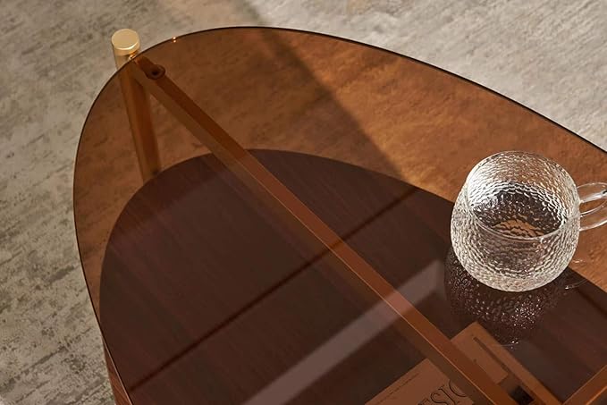 Shrine Oval Coffee Table, Mid-Century Modern Design, 2-Tier Structure, Amber Glass Top and Walnut MDF Shelf, 47" D x 21" W x 17" H, Sleek Conical Metal Legs with Gold Finish