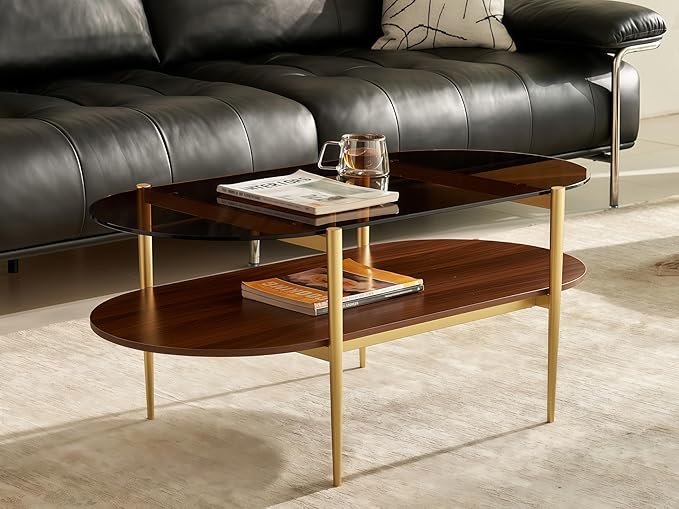 Shrine Oval Coffee Table, Mid-Century Modern Design, 2-Tier Structure, Amber Glass Top and Walnut MDF Shelf, 47" D x 21" W x 17" H, Sleek Conical Metal Legs with Gold Finish