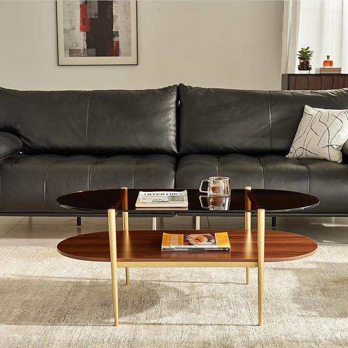 Shrine Oval Coffee Table, Mid-Century Modern Design, 2-Tier Structure, Amber Glass Top and Walnut MDF Shelf, 47" D x 21" W x 17" H, Sleek Conical Metal Legs with Gold Finish