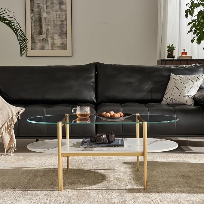 Shrine Oval Coffee Table, Mid-Century Modern Design, 2-Tier Structure, Clear Glass Top and White MDF Shelf, 47" D x 21" W x 17" H, Sleek Conical Metal Legs with Gold Finish