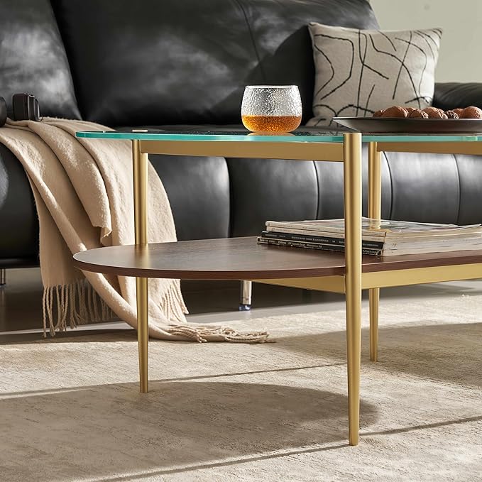 Shrine Oval Coffee Table, Mid-Century Modern Design, 2-Tier Structure, Clear Glass Top and Walnut MDF Shelf, 47" D x 21" W x 17" H, Sleek Conical Metal Legs with Gold Finish