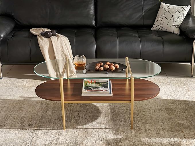 Shrine Oval Coffee Table, Mid-Century Modern Design, 2-Tier Structure, Clear Glass Top and Walnut MDF Shelf, 47" D x 21" W x 17" H, Sleek Conical Metal Legs with Gold Finish